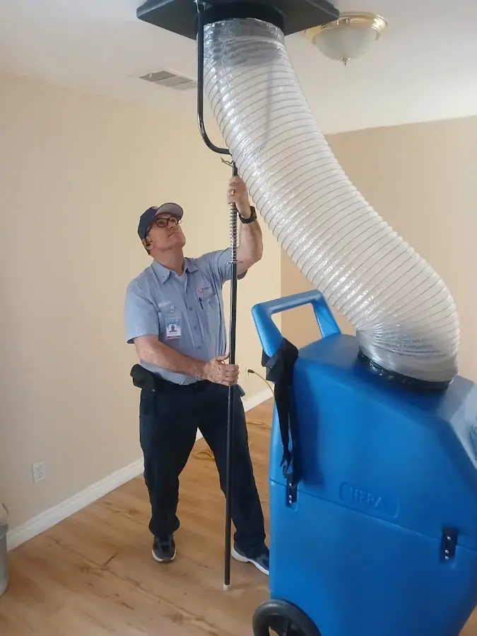 Furnace Tune-Up technician using HEPA equipment in Salton City