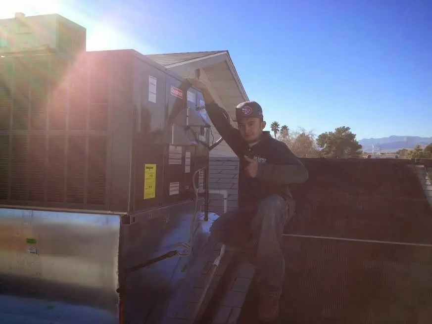 HVAC technician performing AC Tune-Up on a rooftop unit in Salton City